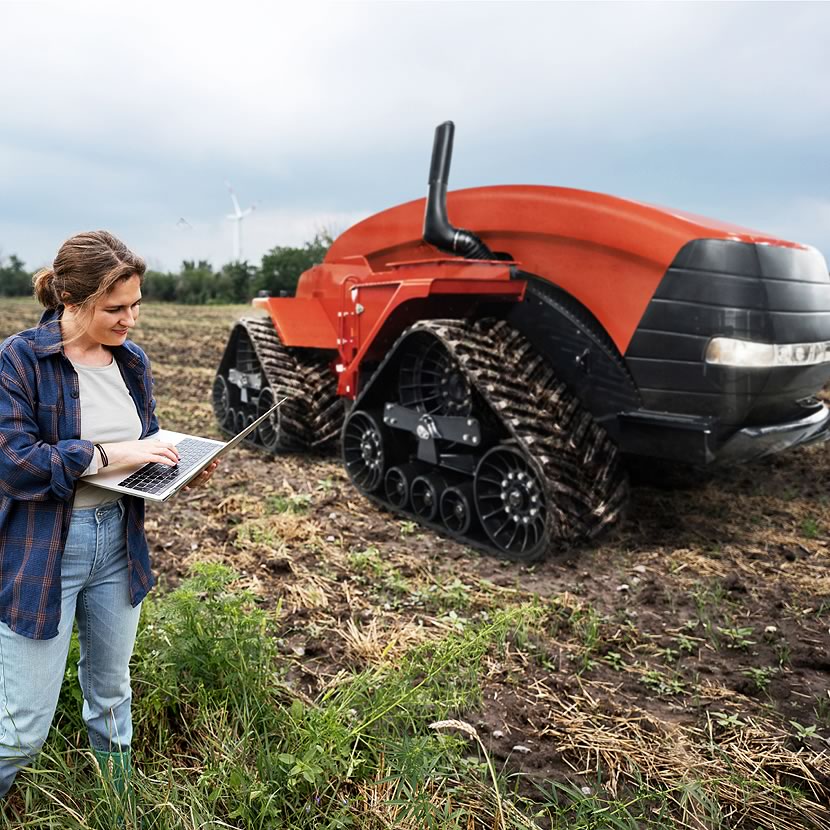 A female farm owner programs a innovative robot tractor to work her field | Crescero Natural Capital